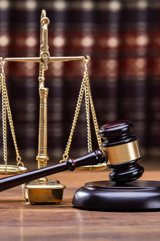 Scales of justice and a gavel on a wooden desk